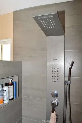 The main suite's bath has been upgraded with a custom, tiled, walk-in shower with a Vevor shower panel system with waterfall and massage jets