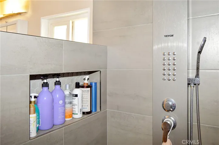The main suite's bath has been upgraded with a custom, tiled, walk-in shower with a Vevor shower panel system with waterfall and massage jets