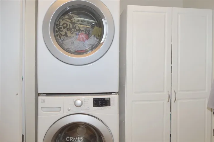 Stackable washer and dryer are included & created added space in the laundry room which has a door to the carport