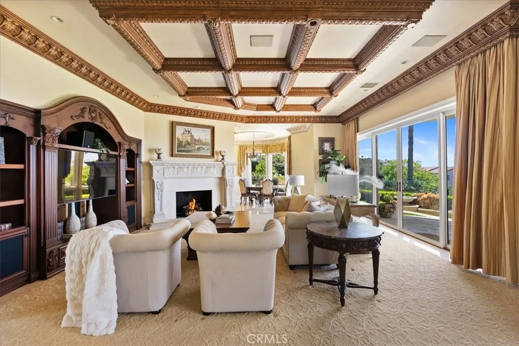 Large Family Room with cozy fireplace, built-in entertainment center, oversized sliding doors that lead to your patio, pool and OCEAN VIEWS!