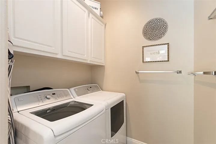 Indoor laundry room with storage.