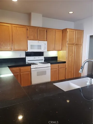 Kitchen with black hard surface