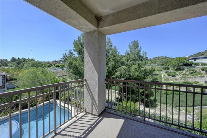 View looking toward the left of the balcony to the backyard pool.