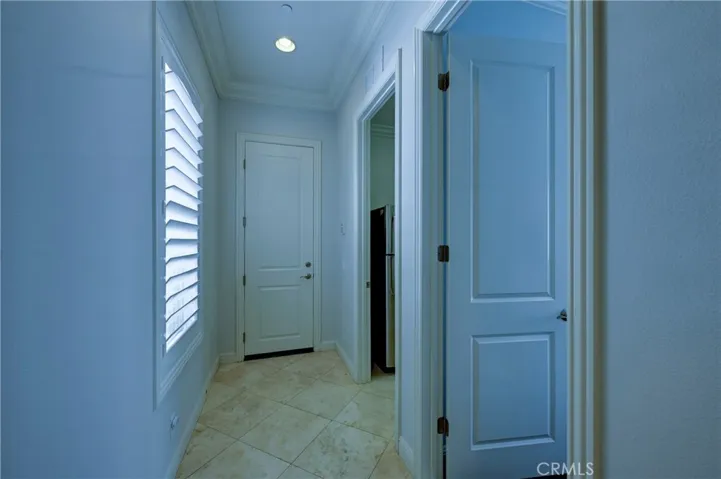 Downstairs hallway to bedroom, laundry & the single garage.