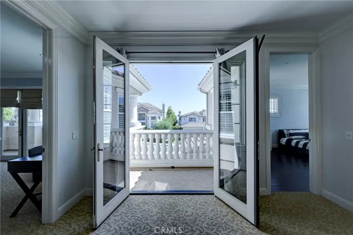 Upstairs balcony, through double doors, looking to the front of the property is in between ensuite bedroom #3 and the bonus room.