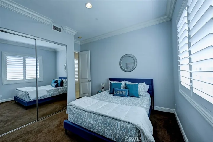 Mirrored wardrobe doors in the downstairs ensuite bedroom.