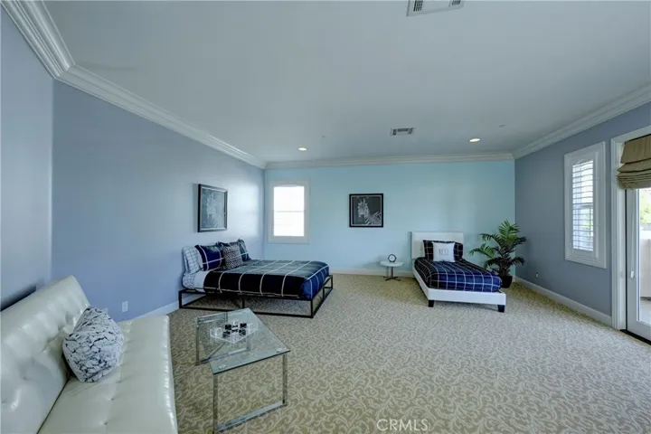 Upstairs bonus / 5th bedroom with carpeted flooring and shutters on the windows.