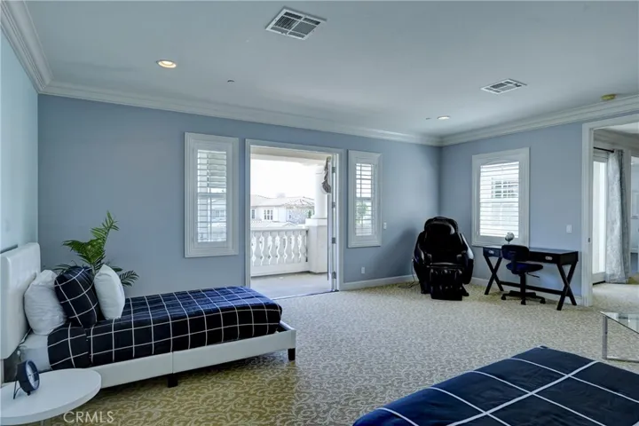 Bonus room with double doors to a balcony.