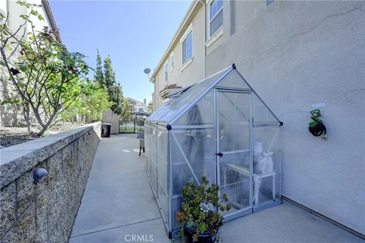 Roomy side yard has a 'green' house.