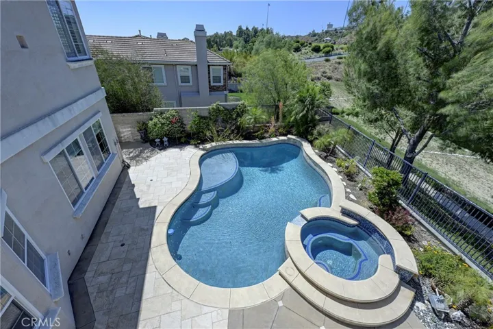View from primary ensuite bedroom to the relaxing pool & spa