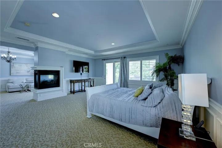 Spacious carpeted primary ensuite & retreat. Note the wainscotting along the walls.