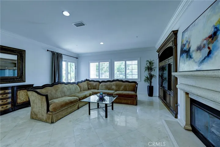 Living room with built in cabinetry, fireplace with mantle and the slider to the backyard.