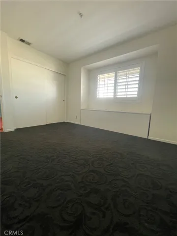 3rd bedroom with large builtin storage chest under the window perfect for toys or linens