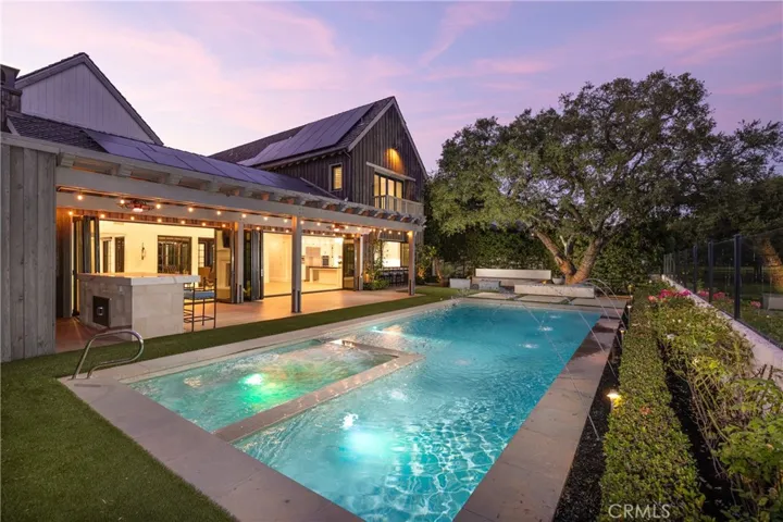 Large pool and spa viewing the equestrian area