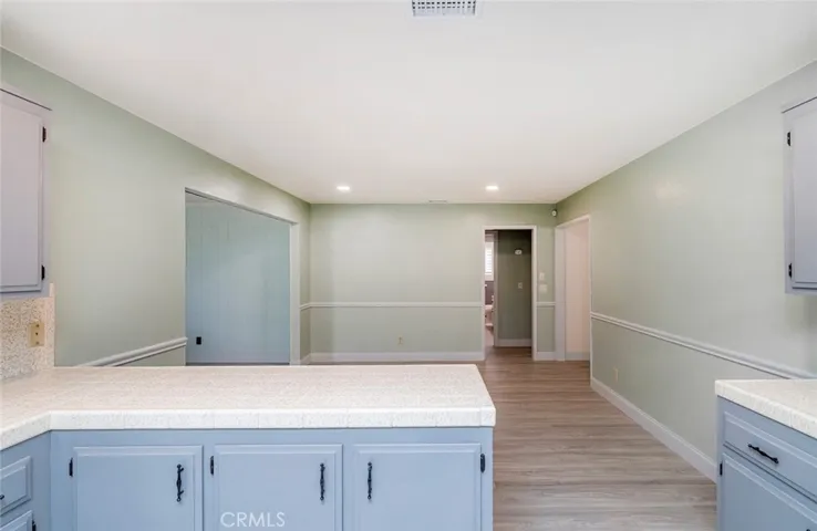 KITCHEN LOOKING INTO DINING AREA WITH WAINSCOTING