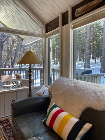 Livingroom with deck and forest view.