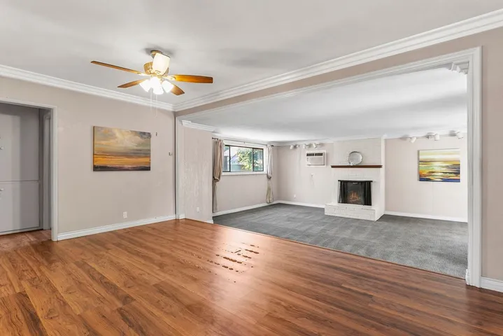 Open living/dining area with crown moulding
