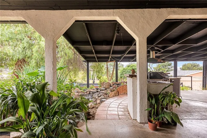 HUGE Backyard with Incredible Patio with Tranquil Water Feature & Outdoor Kitchen!
