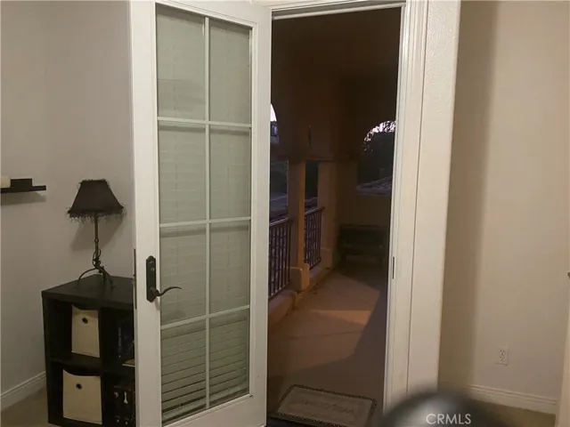 Upstairs bedroom with covered balcony overlooking hills in the front of the house