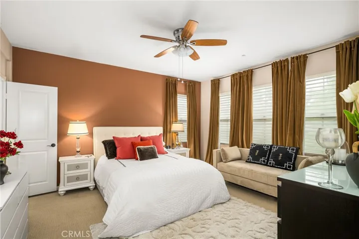 a spacious master bedroom, richly appointed with designer-selected paint & window coverings