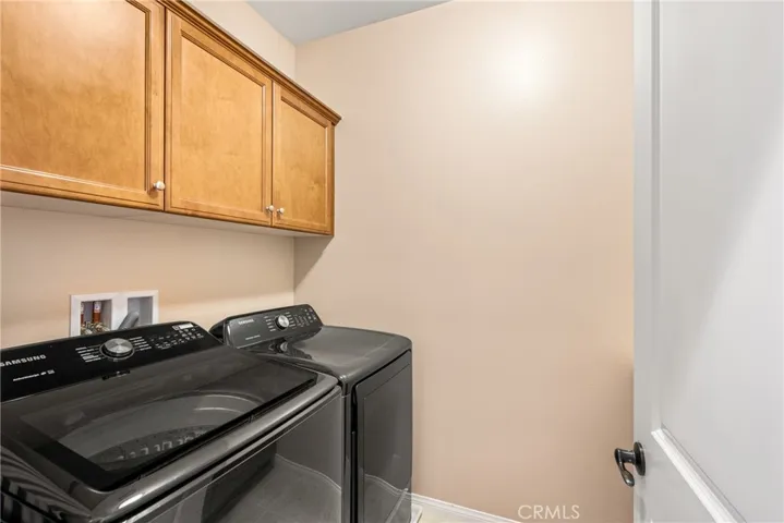 a convenient upstairs laundry room, with storage