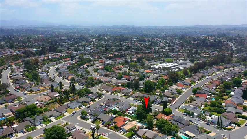 aerial property view shows proximity to school and neighborhood