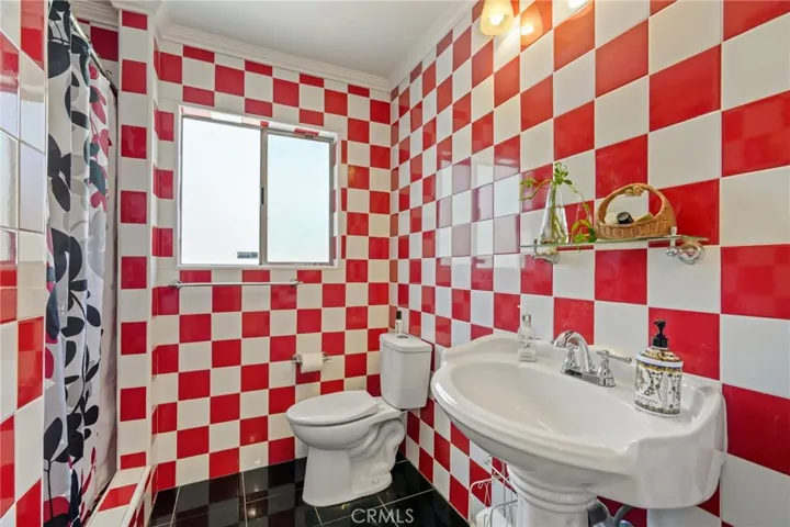 Hallway bathroom with standing shower & pedestal sink
