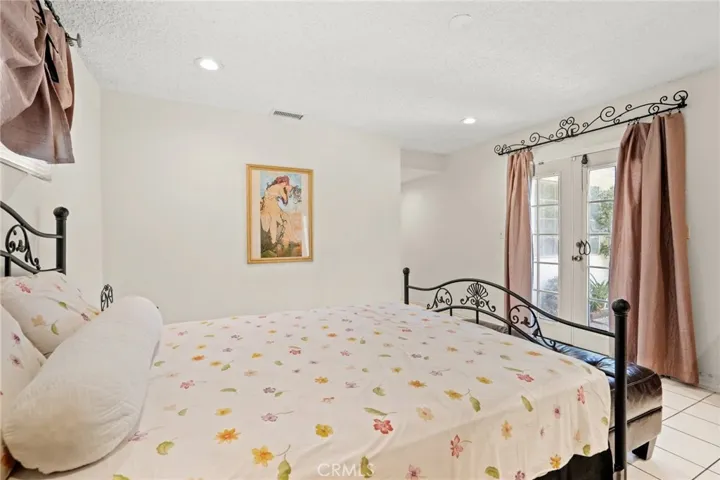 1st Master bedroom has sliding door leading to backyard