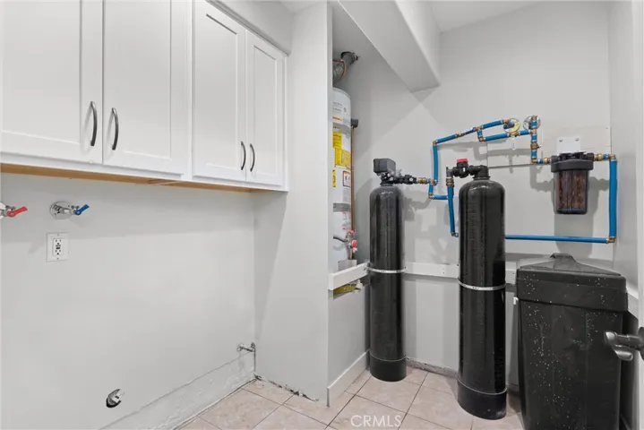 Inside Laundry room with water softener