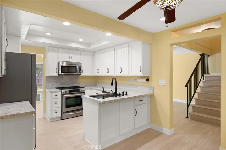 Remodeled Kitchen with white shaker cabinets and Stainless steel appliances