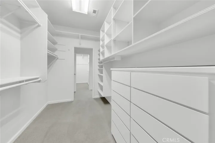 Dual Walk-through Closets that circle back to the Primary Bathroom