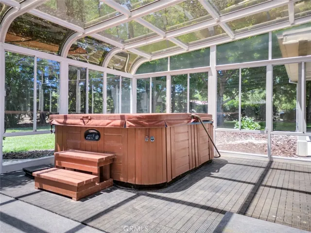 Step through the sliding glass doors from your Primary Suite to enjoy this Atrium with Jacuzzi!