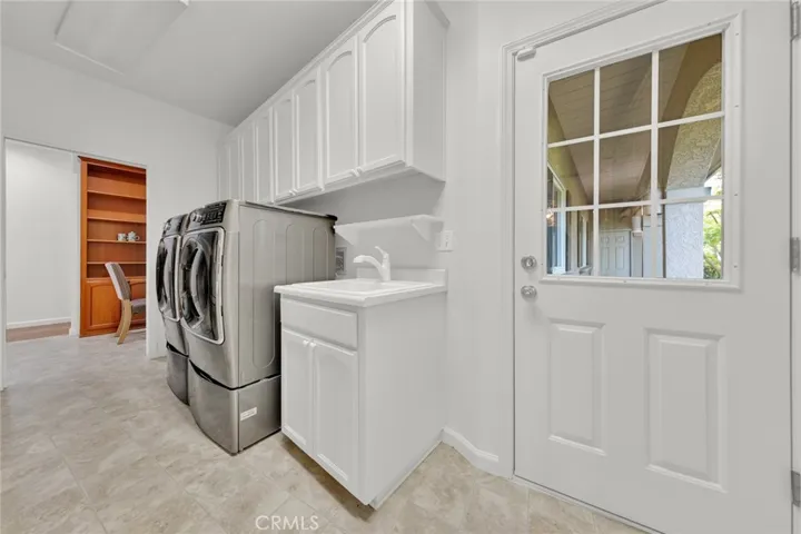 Washer/Dryer Area located in walk through Butler's Pantry just behind the Kitchen.  Even has additional Refrigerator!