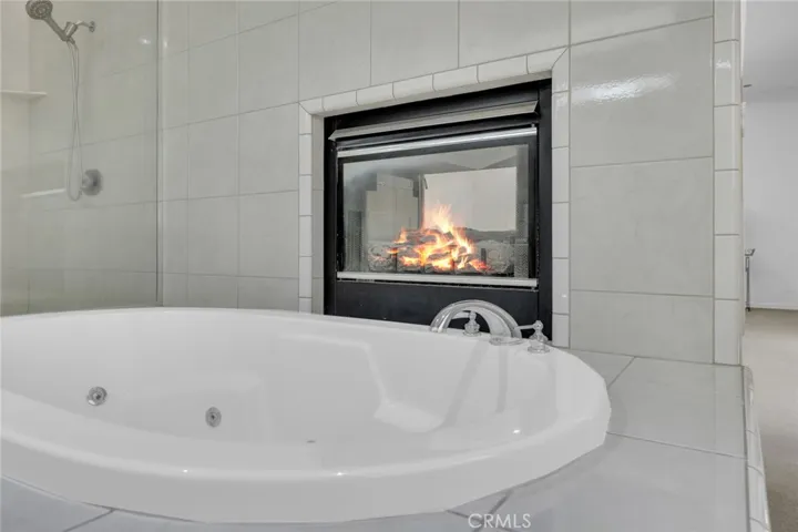 Such luxury having a jacuzzi tub and enjoying a nice fire all at the same time!