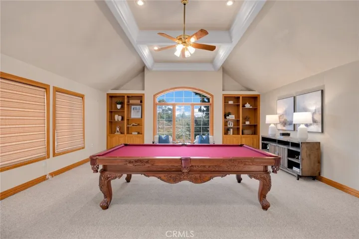 Game room w high ceilings and bar/sink area
