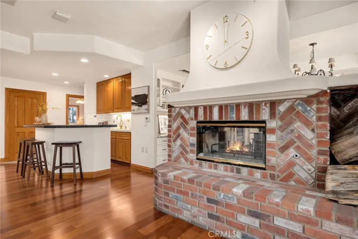 Dual fireplace facing kitchen and family room