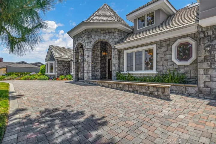 Front of home with paver driveway