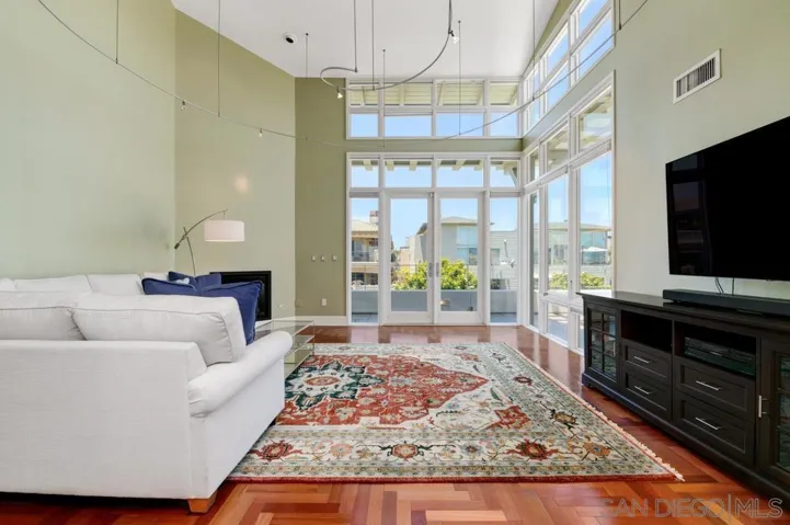 Floor to ceiling windows, entry to large patio overlooking the San Diego Bay.