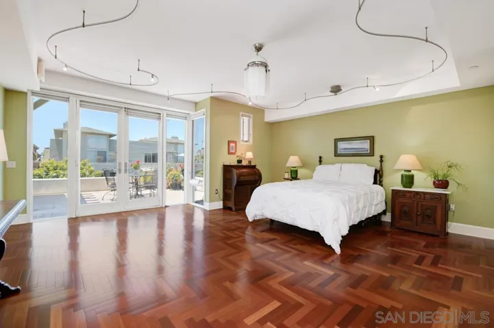 Large primary bedroom, doors open to the patio/deck.