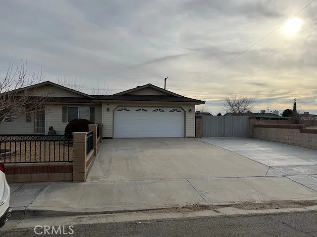 showing 2car garage and lg RV gate