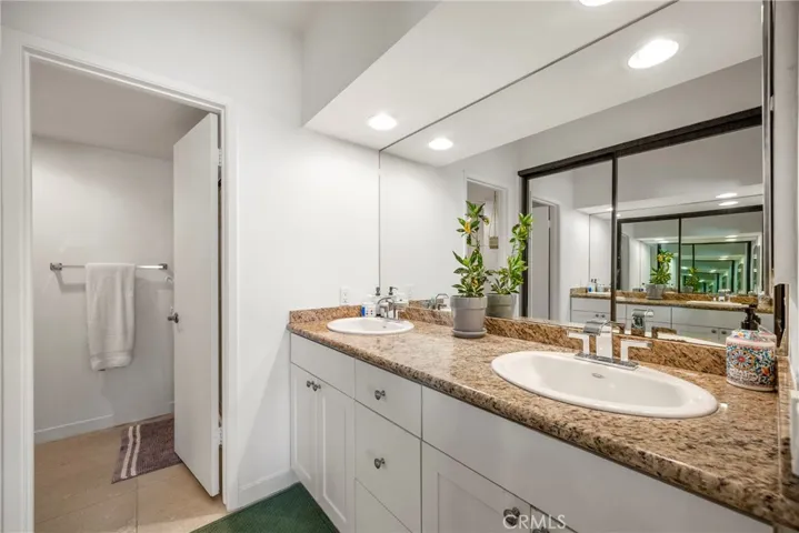 The primary vanity area with dual sinks and a closet.