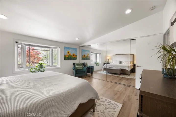 The primary bedroom with a closet the length of the wall.