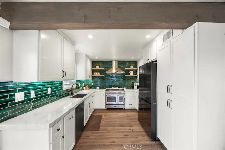 Another view of the kitchen with a lot of cabinet space.
