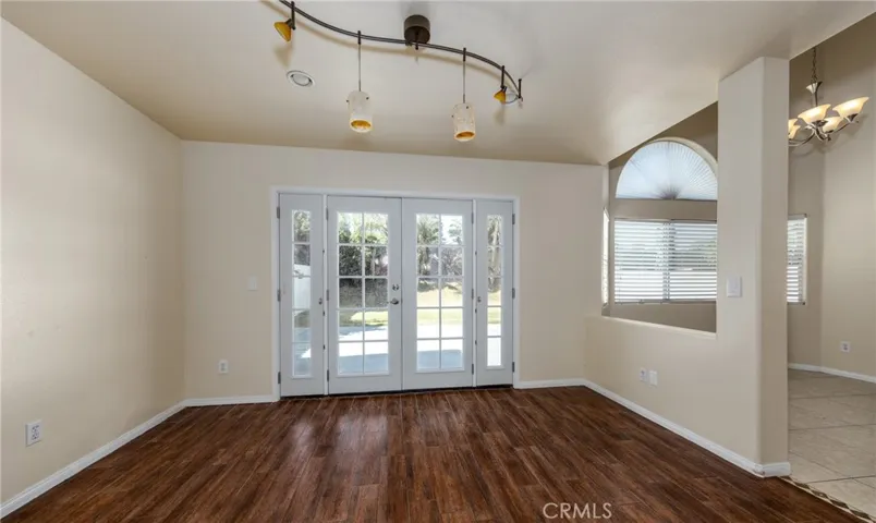 area off kitchen with french doors opening to full length patio and yard