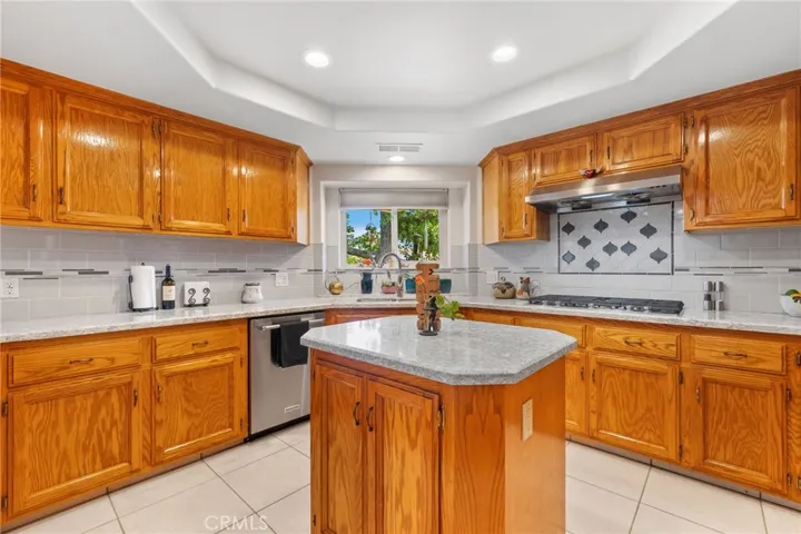 Kitchen: raised ceiling, custom recessed lighting, granite countertops, custom tile full-height backsplashes, stainless steel dishwasher, stainless steel double deep sink, over-sized 5-burner gas cooktop, real stainless steel vent hood, center island.