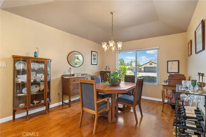 Formal Dining Room: room for table for 10 or 12, hardwood flooring, coffered ceiling, custom lighting, two-tone paint, large window. 2" blinds.