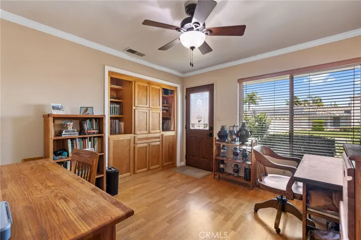 Office/4th Bedroom: full-sized room, hardwood flooring, door to driveway, large windows,  2" blinds, ceiling fan/light, 2-tone paint, custom cabinets & shelving in former closet. The Seller can restore the closet if the Buyer prefers.