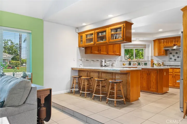 Kitchen: completely remodeled in 2014, granite countertops, full height tile backsplashes, deluxe stainless steel appliances & double deep sink, custom cabinets with pull-out shelves & corner lazy-susan, center island, custom recessed lighting, breakfast bar.