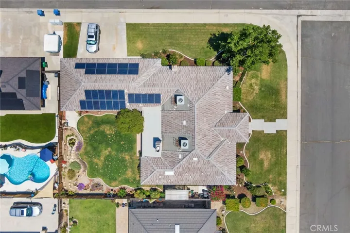 Aerial View: large 10,890 sq.ft. corner lot, room for a pool, 2 16-SEER HVAC units, 2 chimneys/fireplaces, solar system, triple-wide level driveway, flowerbed curbing.
