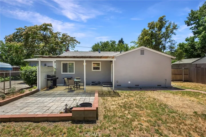 Backyard Shot of Very Sturdy Stucco and Brick Construction with At active Wisteria Vines located on a large quarter acre, mostly fenced-in lot. 1532 Sqft 3/2 hom is also commercially zoned to run your own business from home! Great Soil for Gardening!